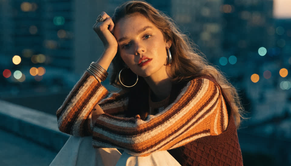 A photoreal night portrait in a striped knit