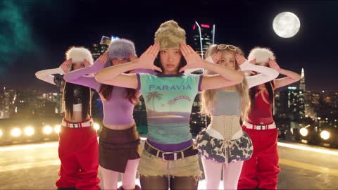 A group of four performing a synchronised routine on a rooftop under a full moon